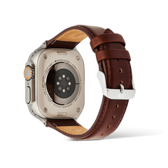 Daniel Wellington St Mawes Leather Strap in brown, shown on the back of an Apple Watch Ultra with a silver pin buckle.