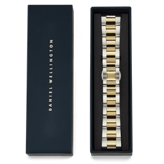 The Smartwatch Iconic Link strap in two-tone silver and gold by Daniel Wellington, shown in its signature navy blue presentation box.