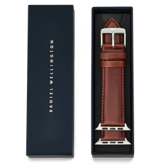 Daniel Wellington Smartwatch Leather Strap St Mawes in brown, featuring a silver pin buckle, presented in its dark blue packaging.