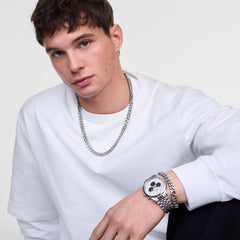 Male model wearing the Daniel Wellington Iconic Chronograph Arch 5-Link watch with an off-white panda dial and silver link bracelet.